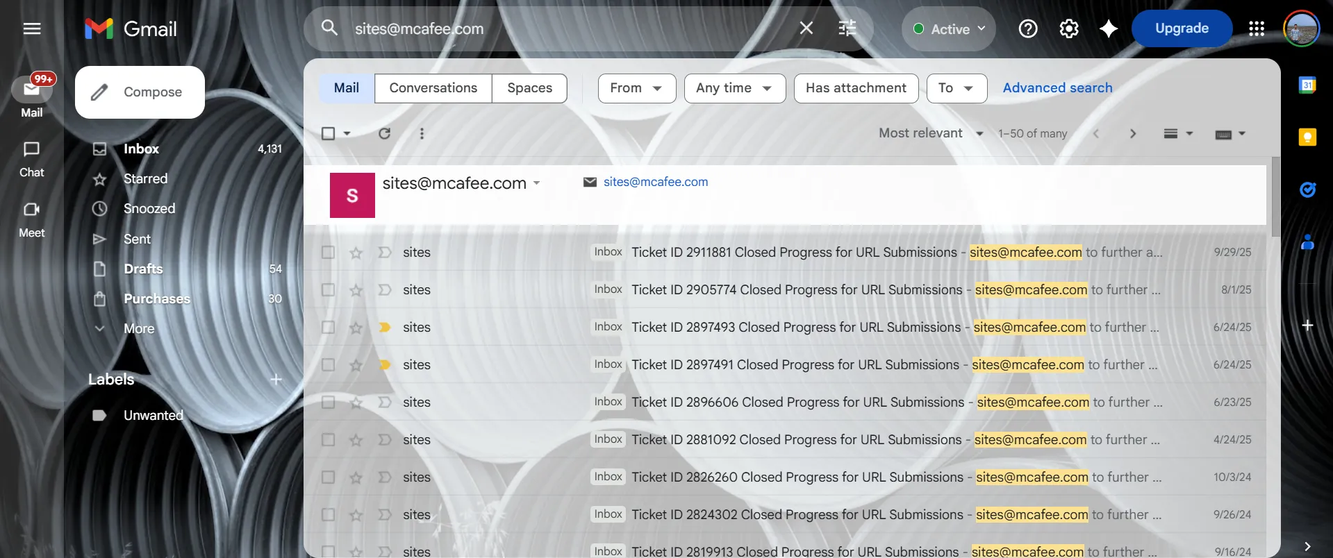 Gmail screenshot showing many emails from McAfee about URL submission tickets and reconsideration results